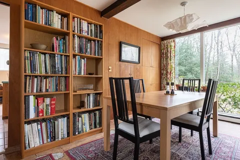 a view of a workspace with furniture and a bookshelf