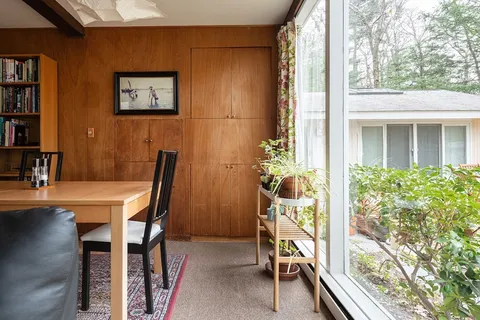 a view of a dining room with furniture window and outside view
