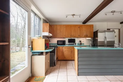 a kitchen with a sink cabinets and window