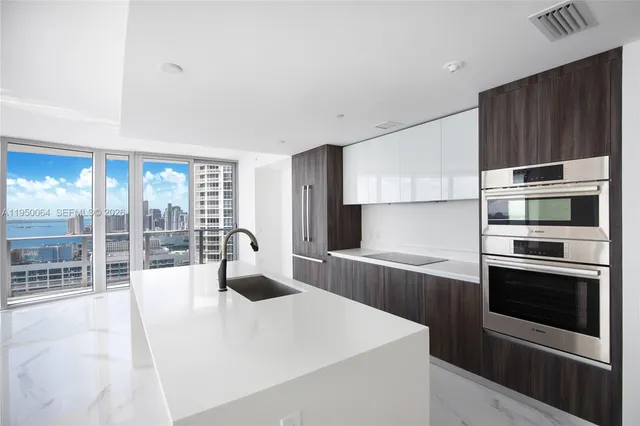 a kitchen with stainless steel appliances a stove and more cabinets