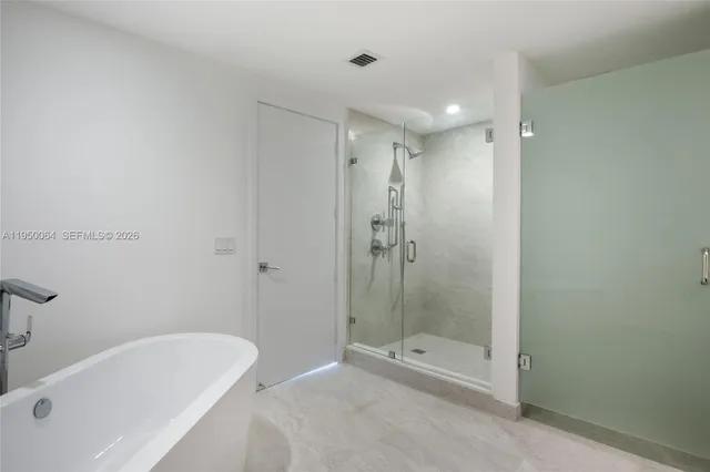 a bathroom with a shower a sink and a mirror