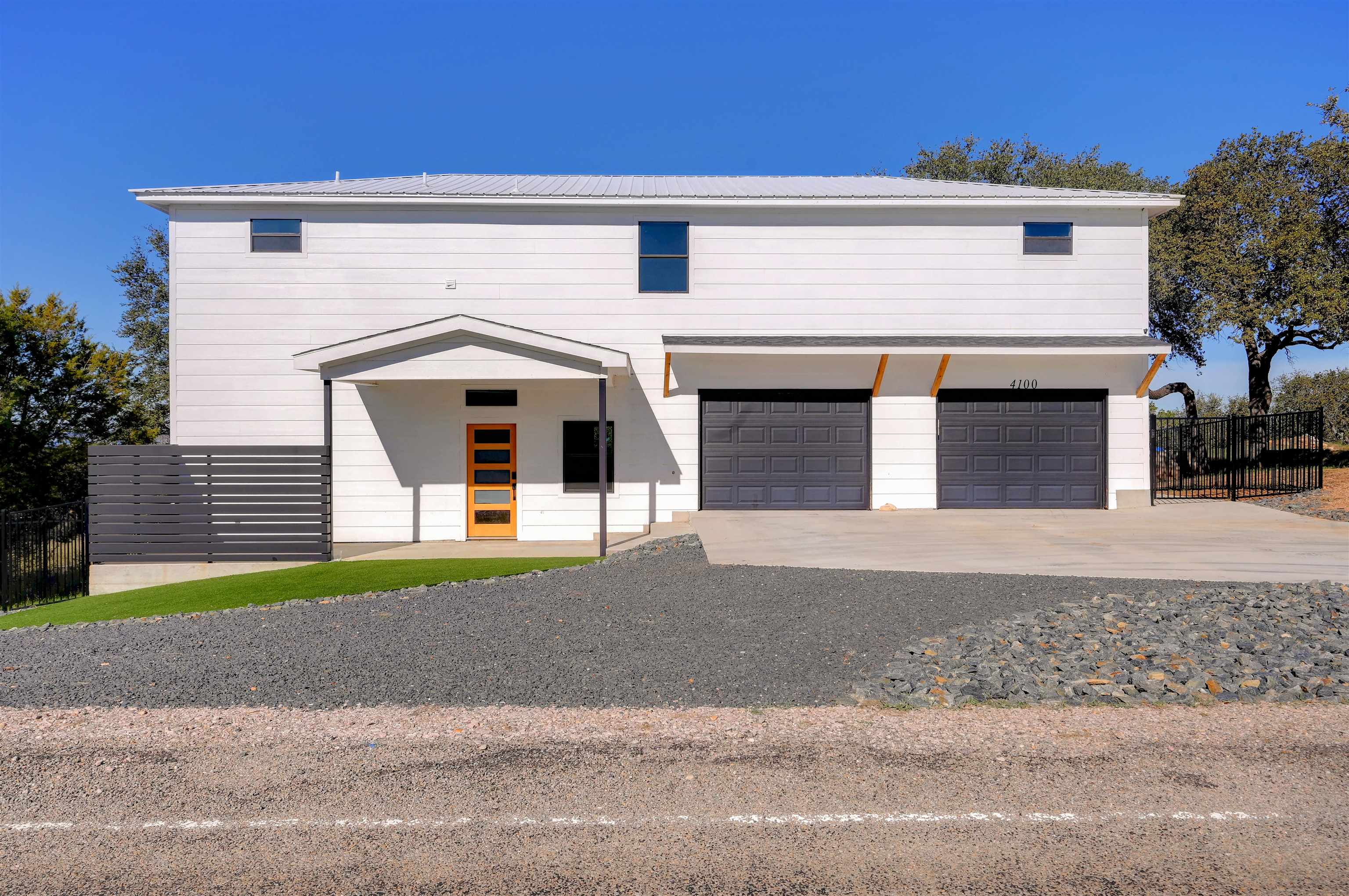 4100 Rm 690 Burnet, TX 78611 - Photo 2 of 30 a front view of a house with a yard and garage