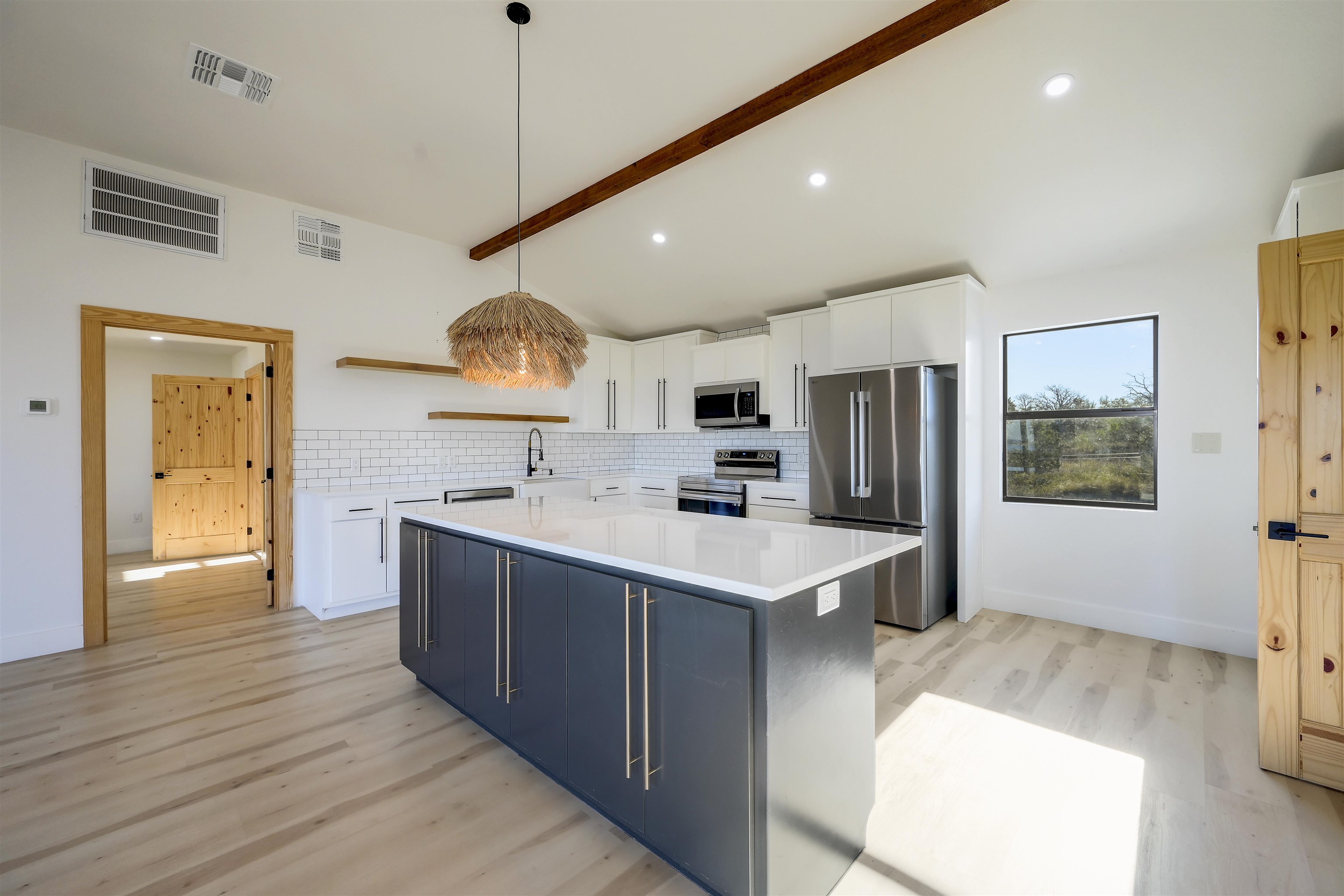 4100 Rm 690 Burnet, TX 78611 - Photo 9 of 30 a kitchen with stainless steel appliances a sink a stove a refrigerator cabinets and wooden floor