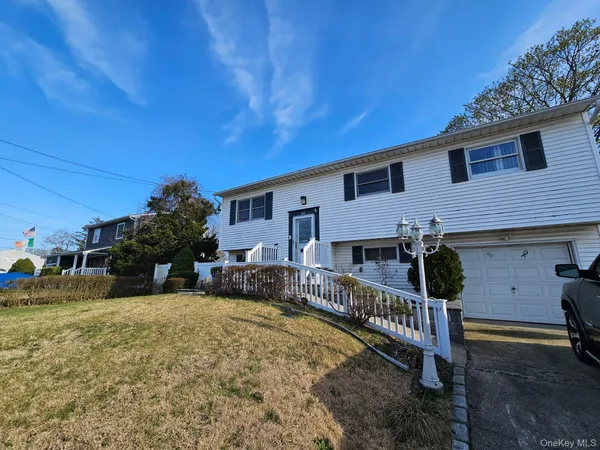 a view of a house with a yard and sitting area