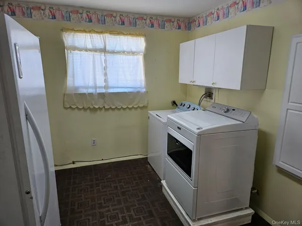 a utility room with a sink a washer and dryer
