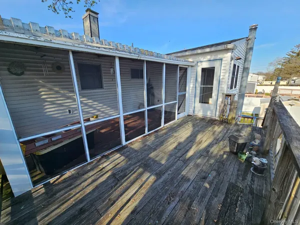 a view of a house with a wooden deck