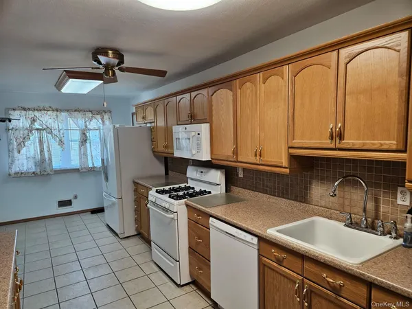 a kitchen with stainless steel appliances a sink stove and refrigerator