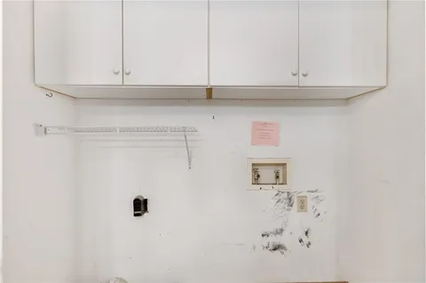 an empty room with a ceiling fan and window