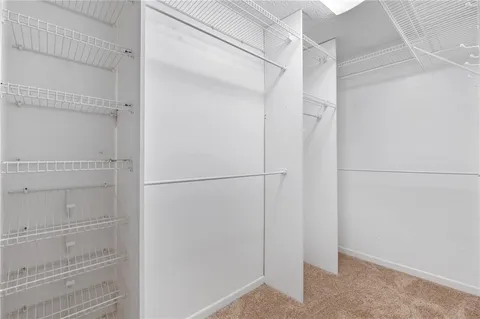 a bathroom with a granite countertop sink a large mirror and a shower