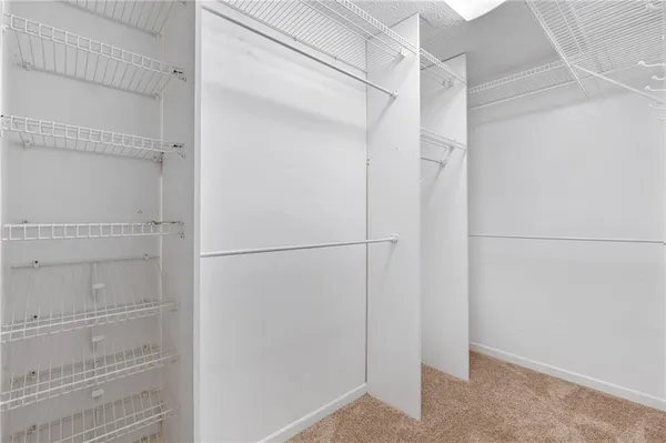 a bathroom with a granite countertop sink a large mirror and a shower