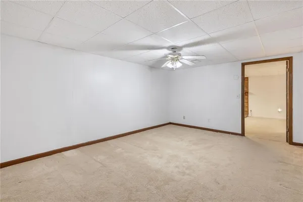 a view of a kitchen with a refrigerator a stove top oven and cabinets