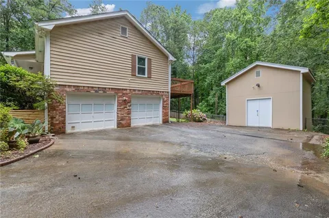 a view of a house with a yard and garage