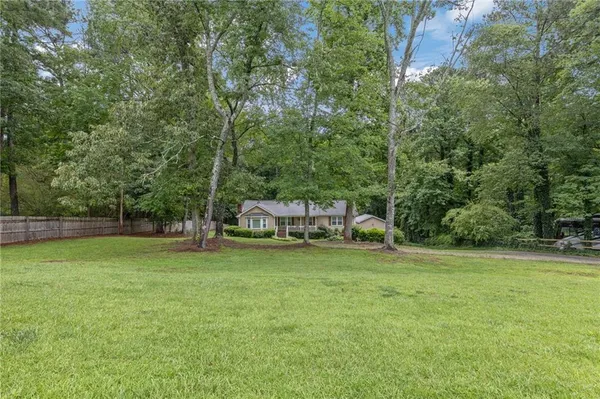 a backyard of a house with table and chairs