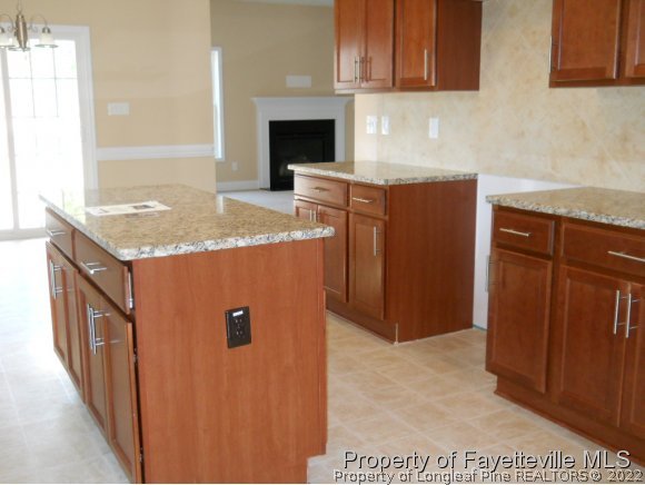 732 Sun Road Aberdeen, NC 28315 - Photo 4 of 7 a kitchen with stainless steel appliances granite countertop a refrigerator and a stove