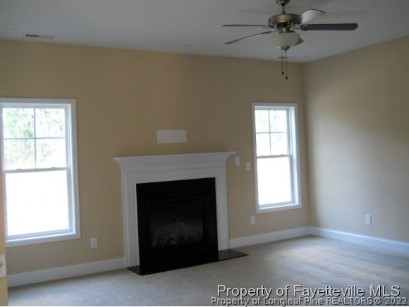 732 Sun Road Aberdeen, NC 28315 - Photo 6 of 7 an empty room with windows and fireplace
