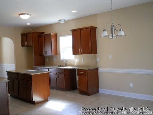 732 Sun Road Aberdeen, NC 28315 - Photo 7 of 7 a kitchen with stainless steel appliances granite countertop a sink and a stove