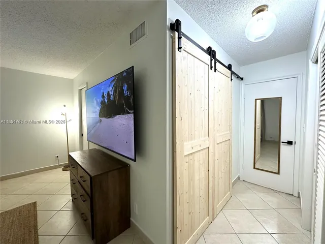 a view of a hallway with paintings on the wall