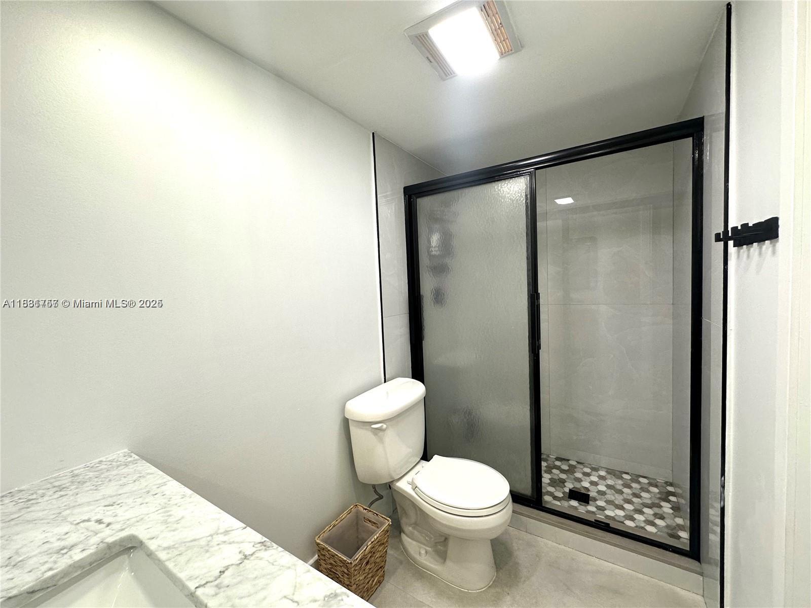 620 Northeast 12th Avenue, Unit 102 Hallandale Beach, FL 33009 - Photo 17 of 23 a bathroom with a toilet and a shower