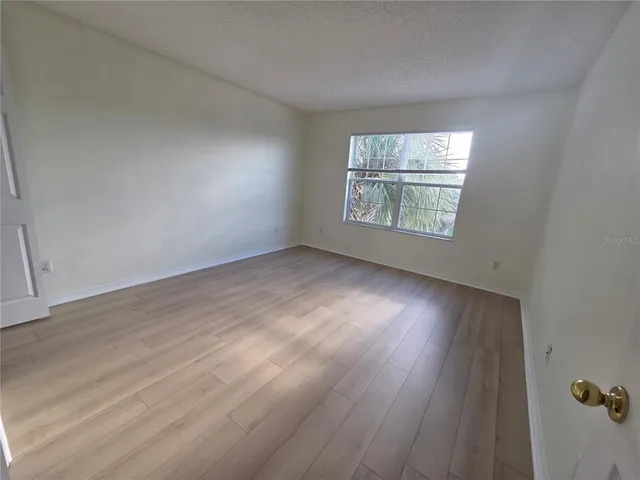 a view of hallway with wooden floor