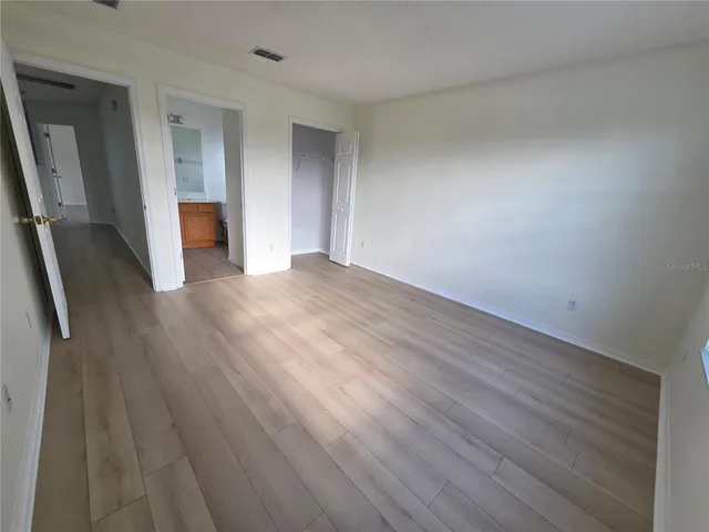 a view of wooden floor and windows in a room