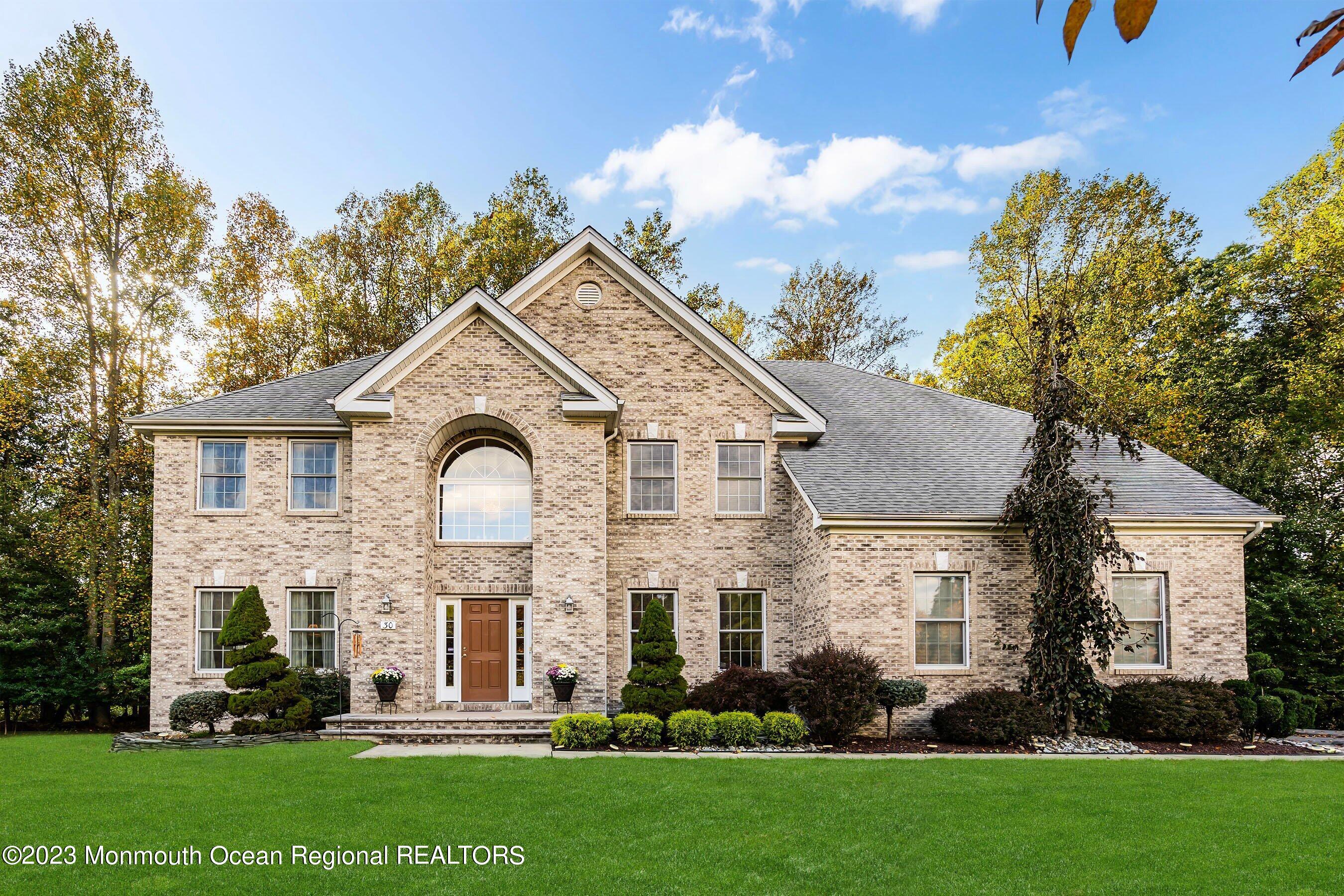 a front view of a house with a garden and plants