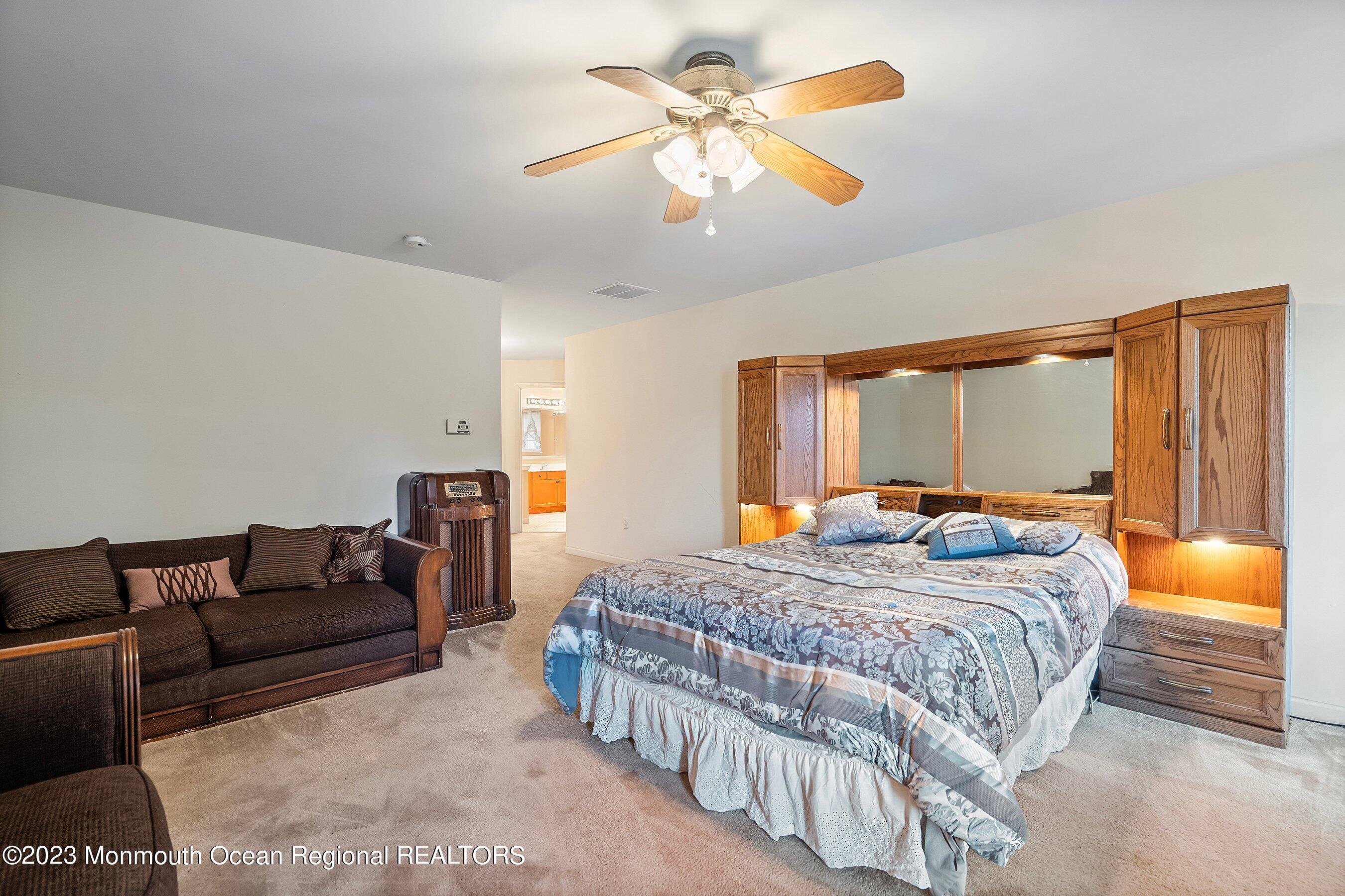 30 Cedar Knoll Road Jackson, NJ 08527 - Photo 18 of 24 a bedroom with a bed and a chandelier