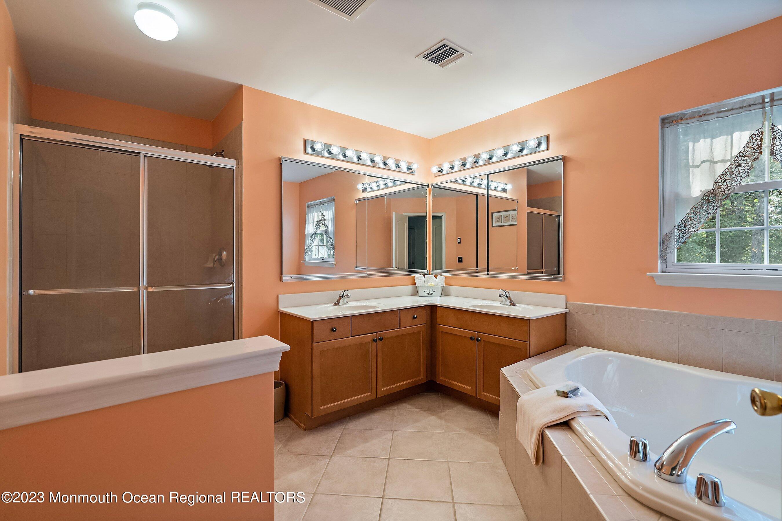 30 Cedar Knoll Road Jackson, NJ 08527 - Photo 19 of 24 a bathroom with a tub sink and mirror