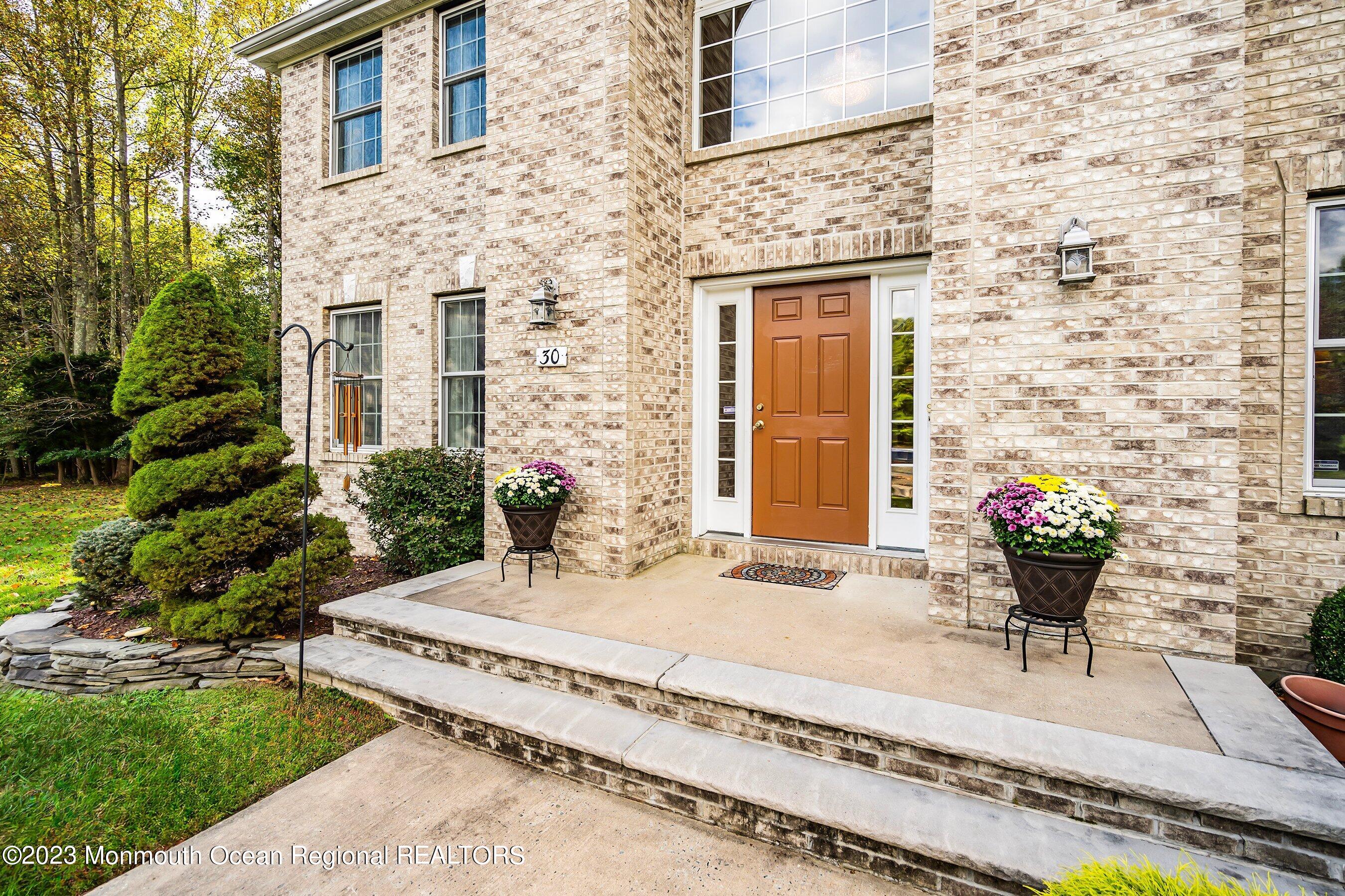 30 Cedar Knoll Road Jackson, NJ 08527 - Photo 2 of 24 a front view of a house with a garden