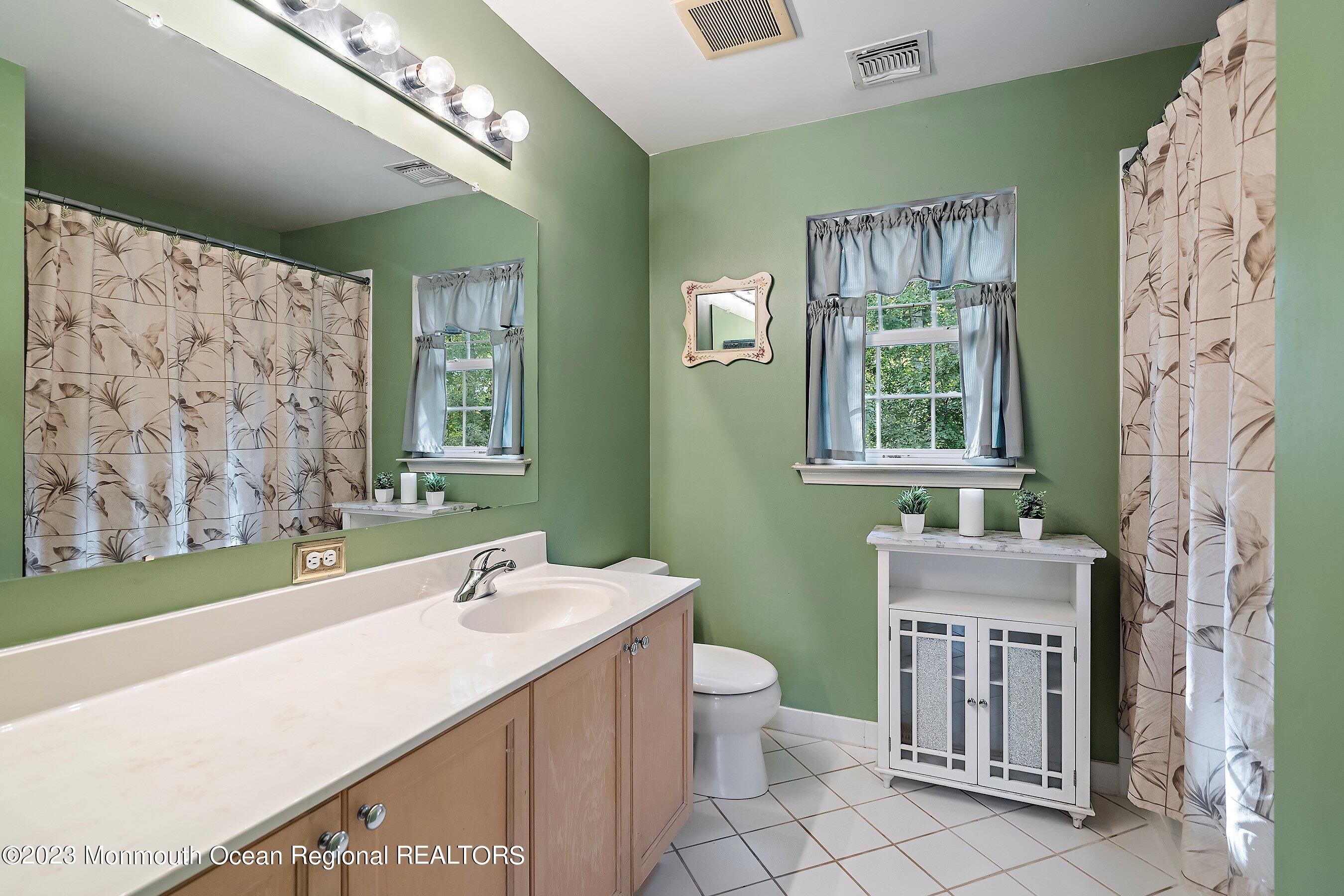 30 Cedar Knoll Road Jackson, NJ 08527 - Photo 24 of 24 a bathroom with a sink a toilet and a mirror