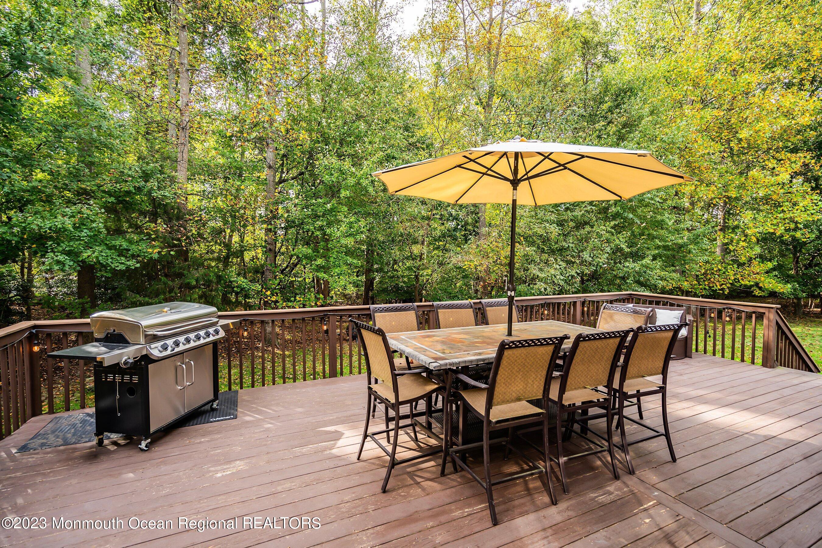 30 Cedar Knoll Road Jackson, NJ 08527 - Photo 8 of 24 a deck of a house with table and chairs