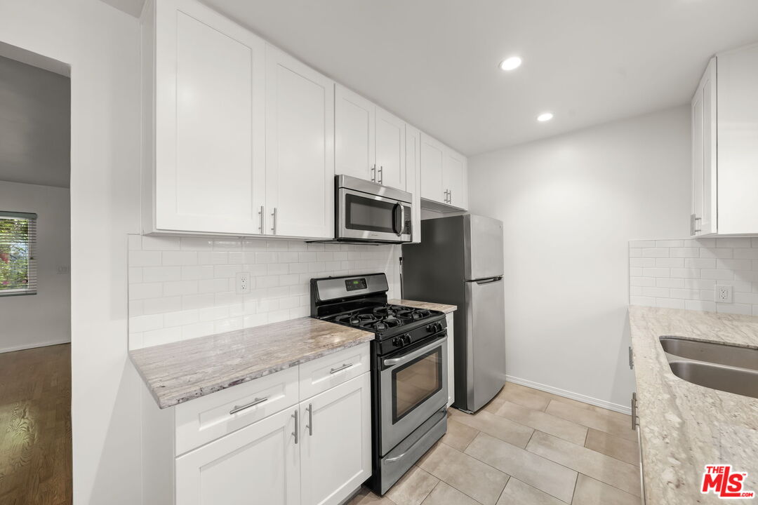 1517 Harvard Street, Unit 3 Santa Monica, CA 90404 - Photo 13 of 20 a kitchen with granite countertop a stove and a sink