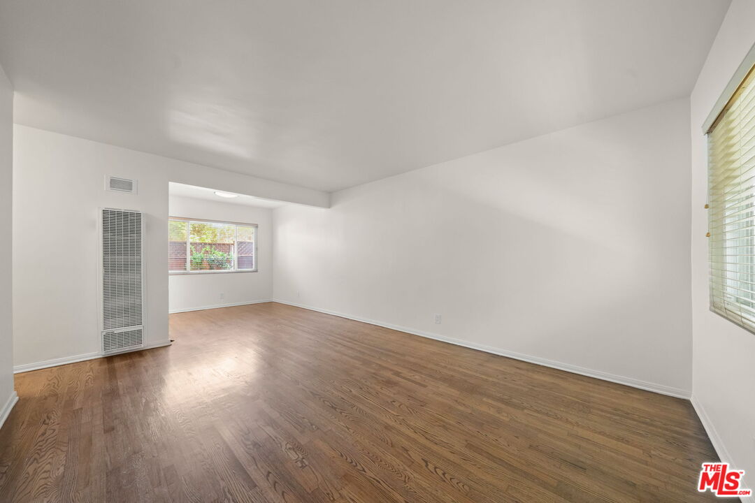1517 Harvard Street, Unit 3 Santa Monica, CA 90404 - Photo 5 of 20 an empty room with wooden floor & windows