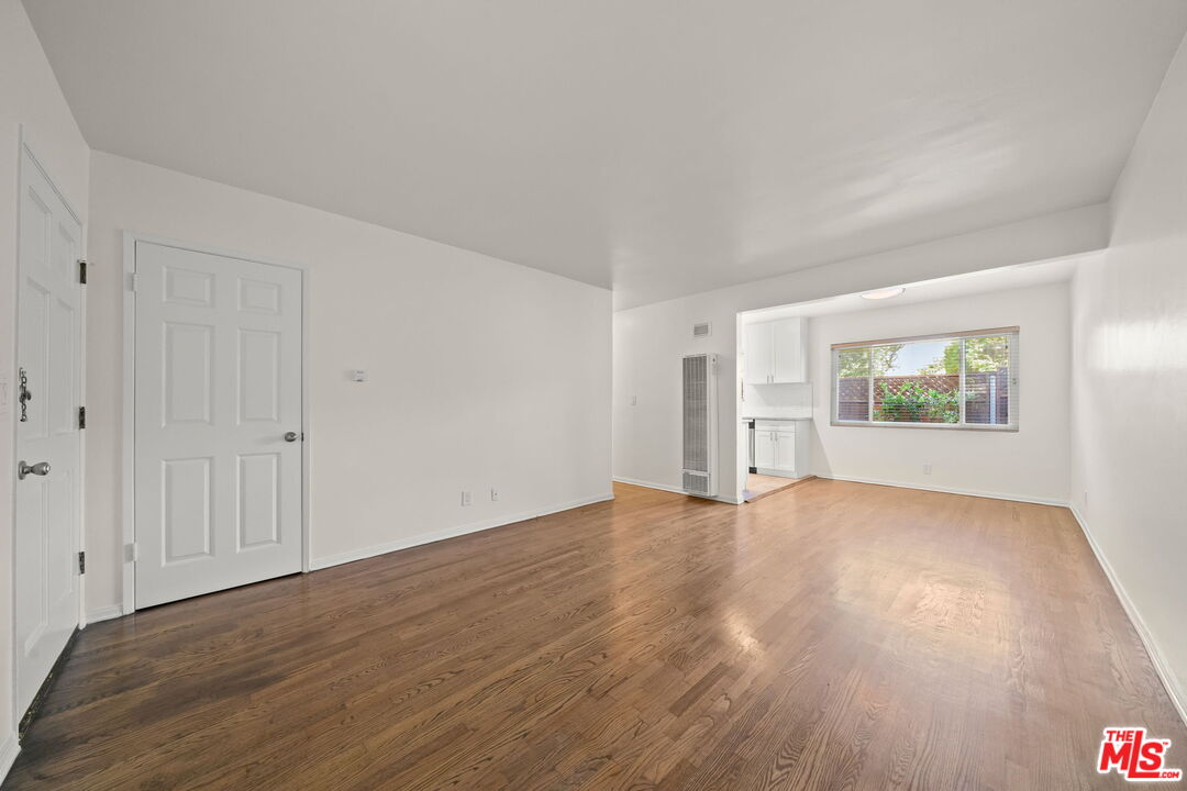 1517 Harvard Street, Unit 3 Santa Monica, CA 90404 - Photo 6 of 20 a view of an empty room with wooden floor and a window