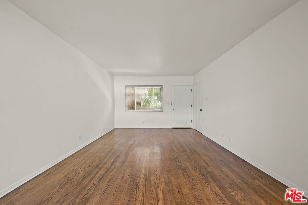 1517 Harvard Street, Unit 3 Santa Monica, CA 90404 - Photo 8 of 20 an empty room with wooden floor and windows