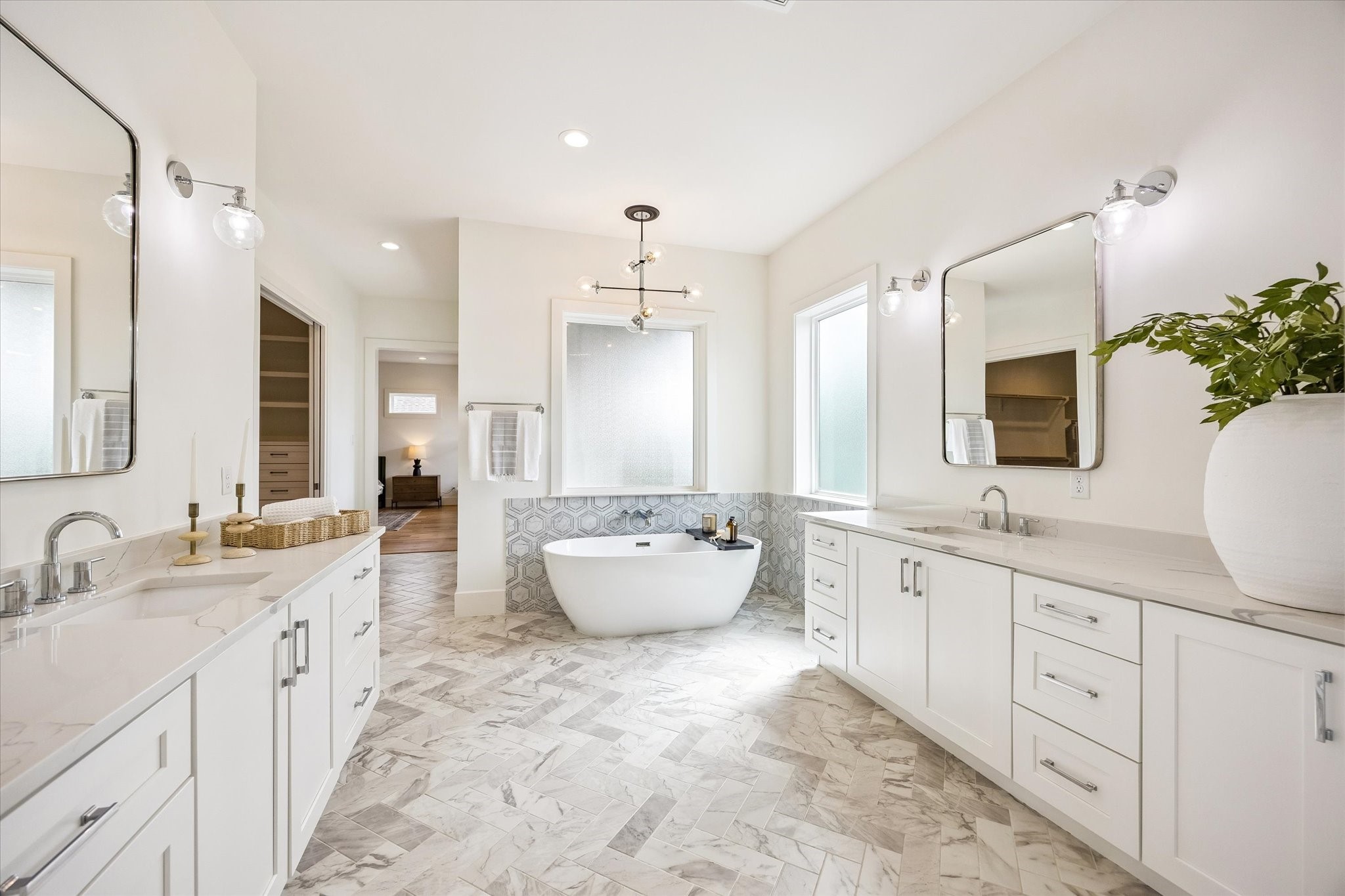 1729 Chippendale Road Houston, TX 77018 - Photo 25 of 45 A light, airy color palette, abundant natural light and sleek silver modern finishes complete the sophisticated look of the primary bathroom.