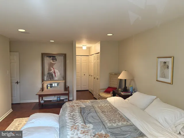 a bedroom with a bed and a lamp on table