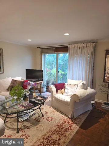 a bedroom with furniture and a flat screen tv