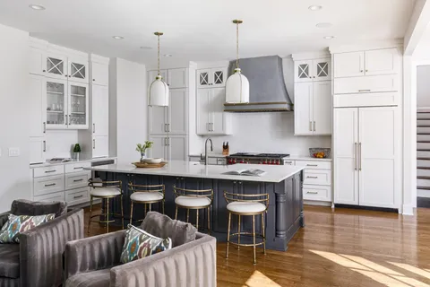 a kitchen with white cabinets and appliances