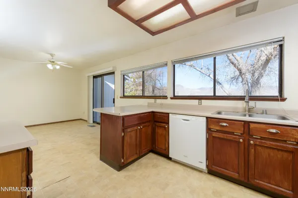a kitchen with granite countertop a sink and cabinets