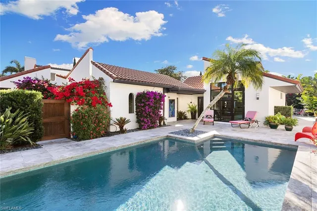 a view of a house with swimming pool and sitting area