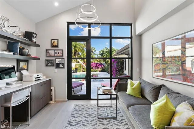 a living room with furniture a window and a flat screen tv