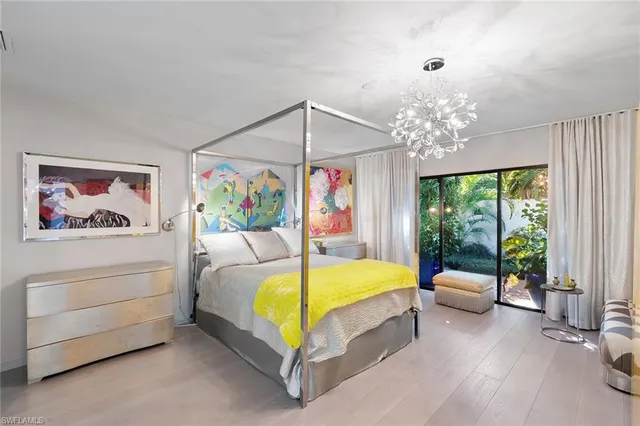 a bedroom with a bed and a painting on the wall