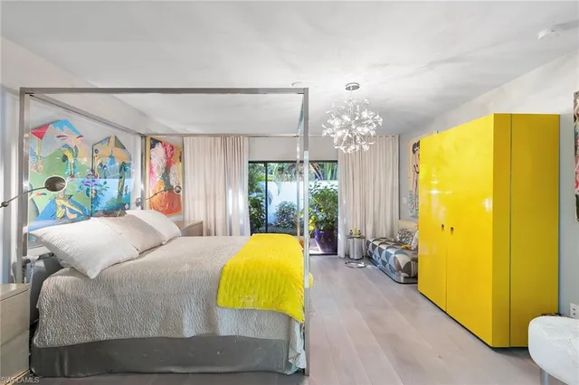 a bedroom with a bed window and lamps