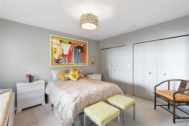 a bedroom with a bed and a painting on the wall