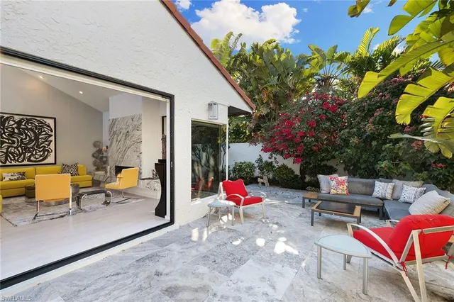 a backyard of a house with outdoor seating