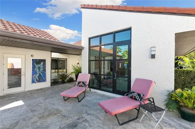 a view of a patio with table and chairs and potted plants