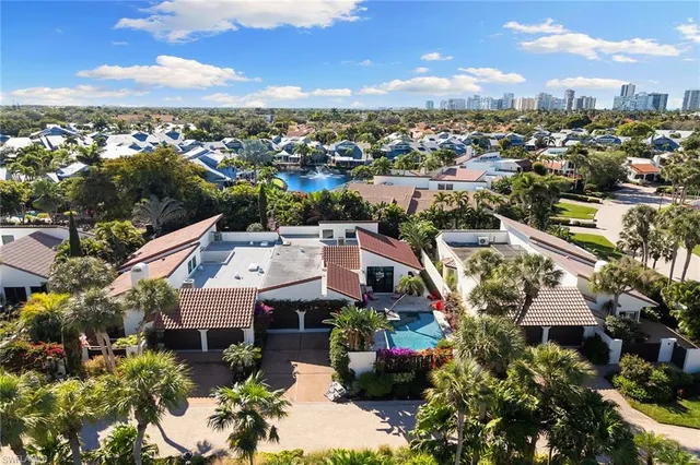 an aerial view of residential houses with city view
