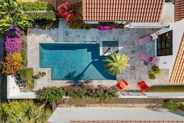 an aerial view of residential houses with outdoor space and street view