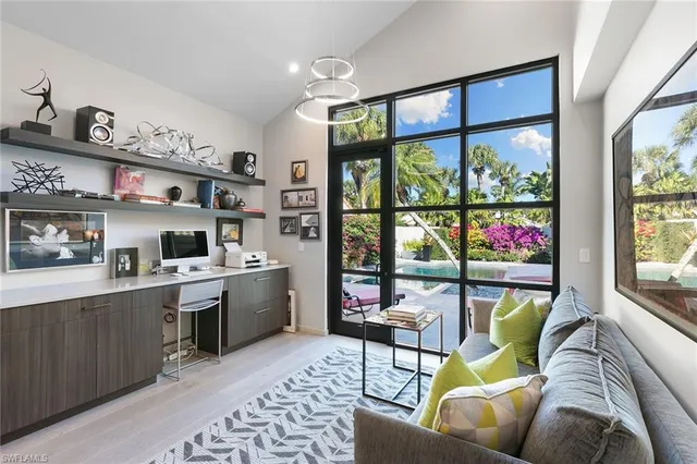 a living room with furniture a window and a flat screen tv