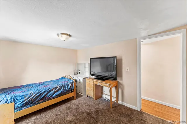 a living room with flat screen tv and gym equipment